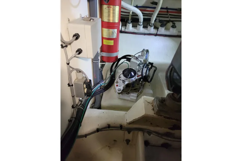 Slide: The Image of Engine room of 1998 Tollycraft 65 Pilothouse with fire extinguisher and mechanical components. - 67