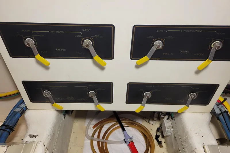 Slide: The Image of Fuel distribution manifold of a 1998 Tollycraft 65 Pilothouse yacht with labeled levers. - 68