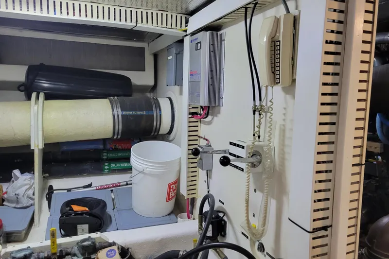 Slide: The Image of Engine room of a 1998 Tollycraft 65 Pilothouse yacht with control panel and equipment. - 70