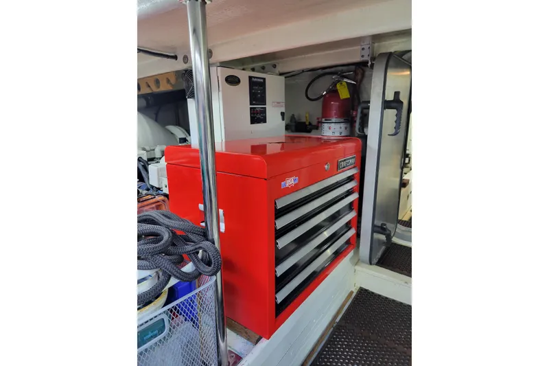 Slide: The Image of Red tool chest in 1998 Tollycraft 65 pilothouse engine room, with fire extinguisher nearby. - 76