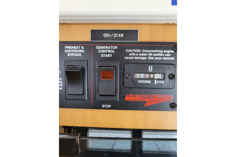 Slide: The Image of Control panel of a 1998 Tollycraft 65 Pilothouse generator, showing switches and hour meter. - 78