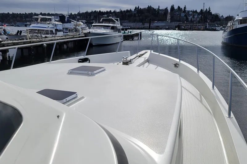 Slide: The Image of 1998 Tollycraft 65 Pilothouse yacht docked at marina, showcasing sleek deck design. - 9