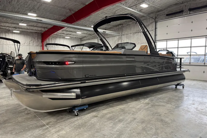 Slide: The Image of 2026 Sylvan G5 pontoon boat in a showroom, featuring sleek design and modern amenities. - 10