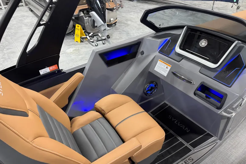 Slide: The Image of Interior of 2026 Sylvan G5 boat with modern dashboard and tan seating. - 17