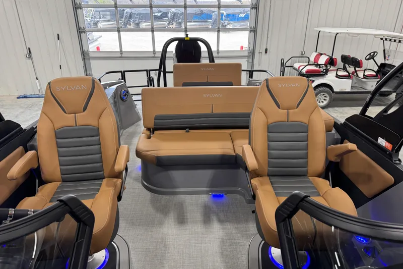 Slide: The Image of 2026 Sylvan G5 boat interior with tan and gray seating, blue LED lighting. - 18