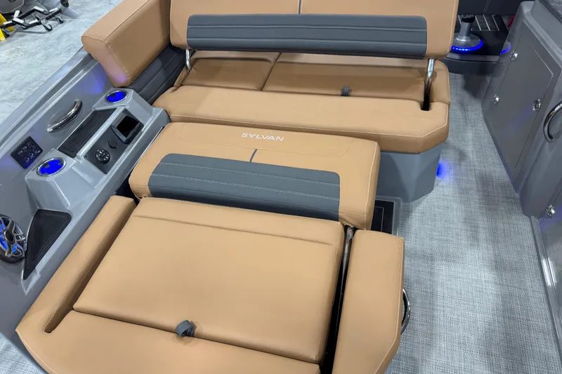 Slide: The Image of 2026 Sylvan G5 boat interior with tan and gray seating, cup holders, and control panel. - 19