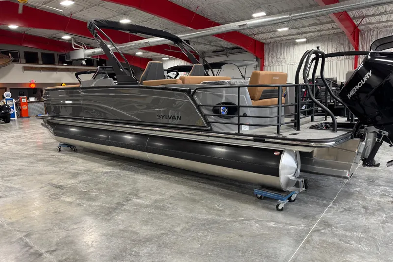 Slide: The Image of 2026 Sylvan G5 pontoon boat in showroom, featuring sleek design and Mercury outboard motor. - 4