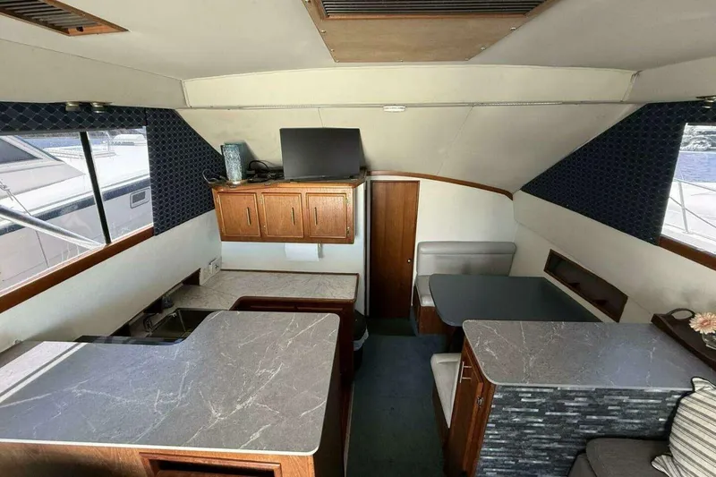 Slide: The Image of Interior of 1988 Ocean Yachts 35 Super Sport with modern kitchen and seating area. - 10