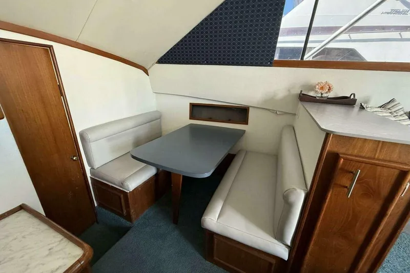 Slide: The Image of Interior of 1988 Ocean Yachts 35 Super Sport with dining area and wooden cabinetry. - 12