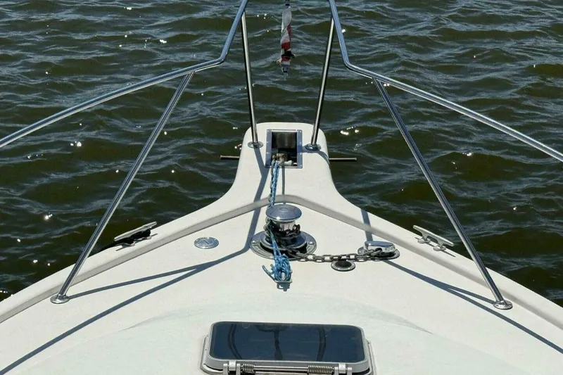 Slide: The Image of Bow view of 1988 Ocean Yachts 35 Super Sport on water, showcasing deck and railing. - 8