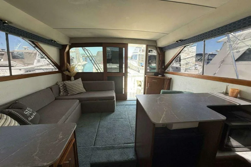 Slide: The Image of Interior of 1988 Ocean Yachts 35 Super Sport with cozy seating and large windows. - 9