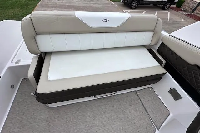 Slide: The Image of 2014 Regal 27 FasDeck boat seating area with beige and white upholstery. - 17