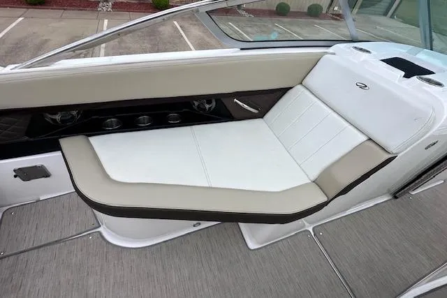 Slide: The Image of 2014 Regal 27 FasDeck boat interior with beige and white seating. - 18