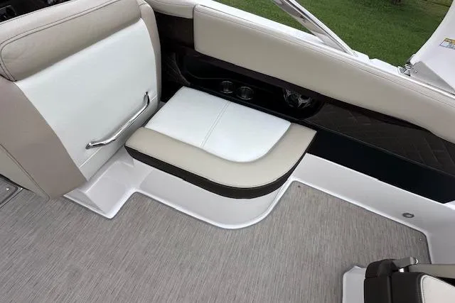 Slide: The Image of 2014 Regal 27 FasDeck boat interior seating with beige and white upholstery. - 19