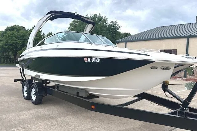 Slide: The Image of 2014 Regal 27 FasDeck boat on trailer, parked outdoors. - 2