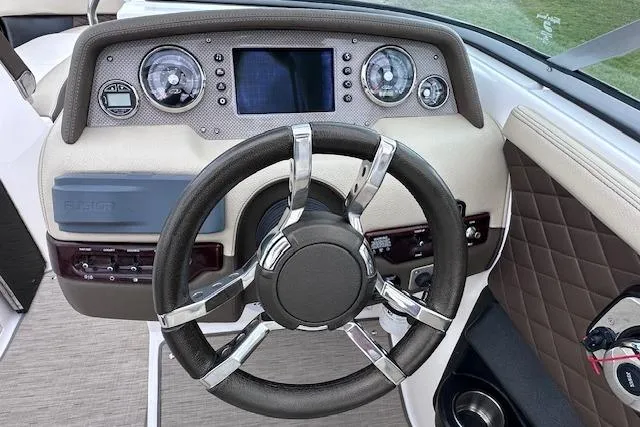 Slide: The Image of Steering wheel and dashboard of 2014 Regal 27 FasDeck boat, featuring modern controls. - 21