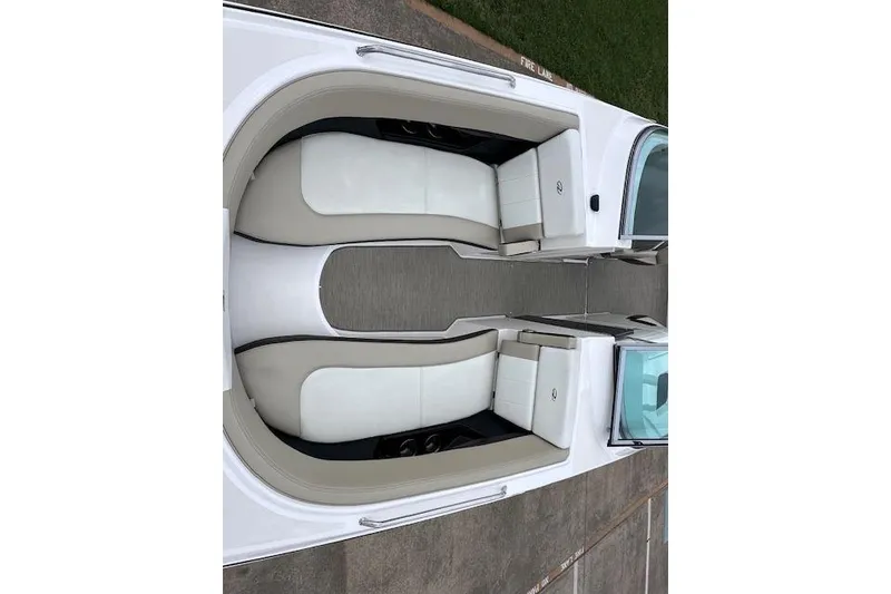 Slide: The Image of 2014 Regal 27 FasDeck boat interior with white and beige seating, overhead view. - 24