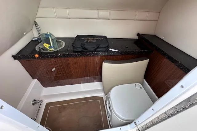 Slide: The Image of 2014 Regal 27 FasDeck boat interior with sink, countertop, and toilet. - 26