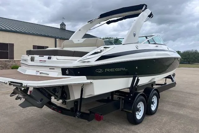Slide: The Image of 2014 Regal 27 FasDeck boat on trailer, parked outdoors under cloudy sky. - 5