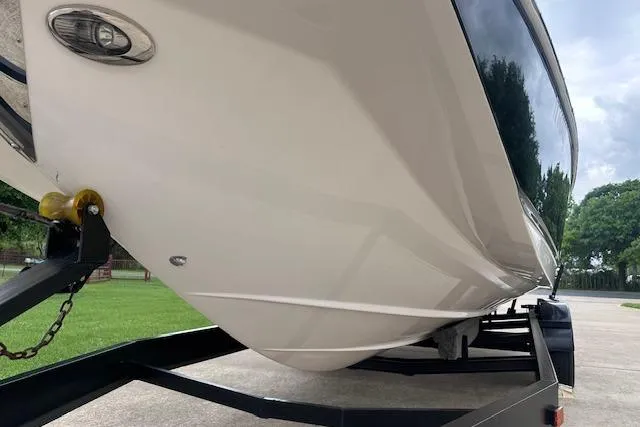 Slide: The Image of 2014 Regal 27 FasDeck boat on trailer, showcasing sleek hull design. - 9