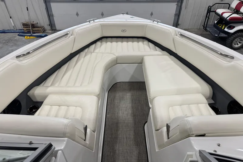 Slide: The Image of 2016 Cobalt R7 boat interior with white leather seating in a garage setting. - 10