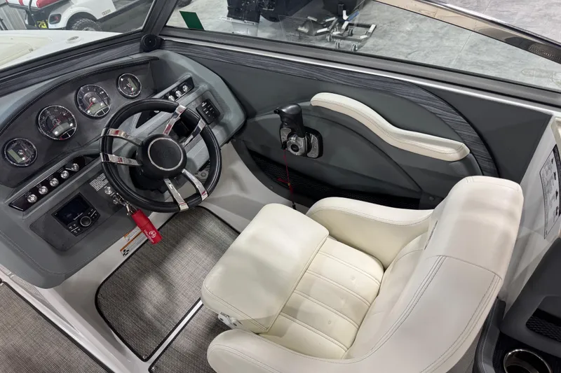 Slide: The Image of Interior of a 2016 Cobalt R7 boat featuring a sleek dashboard and comfortable seating. - 12