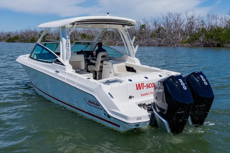 The Image of 2021 Boston Whaler 280 Vantage boat cruising on water with twin Mercury engines. - 0