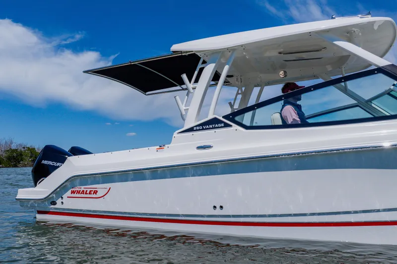 Slide: The Image of 2021 Boston Whaler 280 Vantage boat cruising on water under clear blue sky. - 12