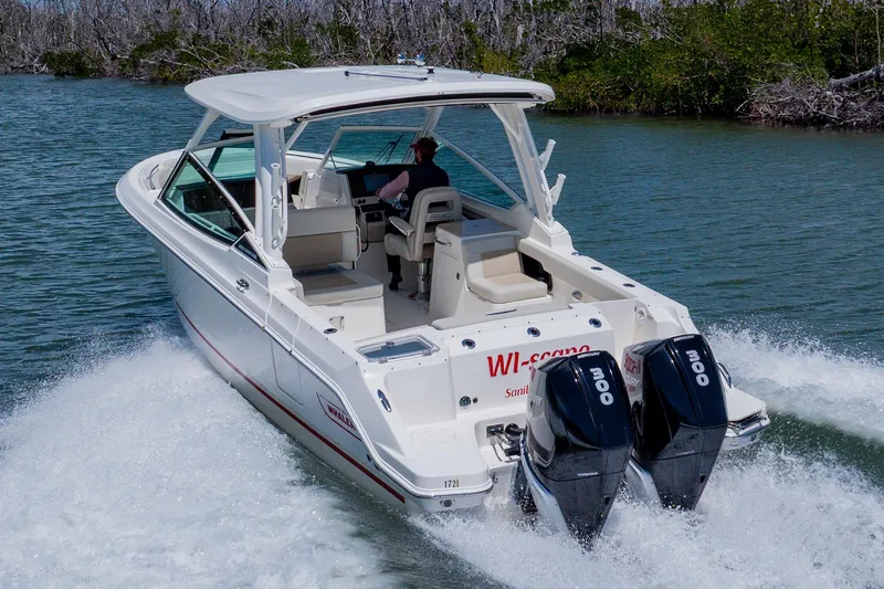 Slide: The Image of 2021 Boston Whaler 280 Vantage cruising on a scenic waterway. - 13