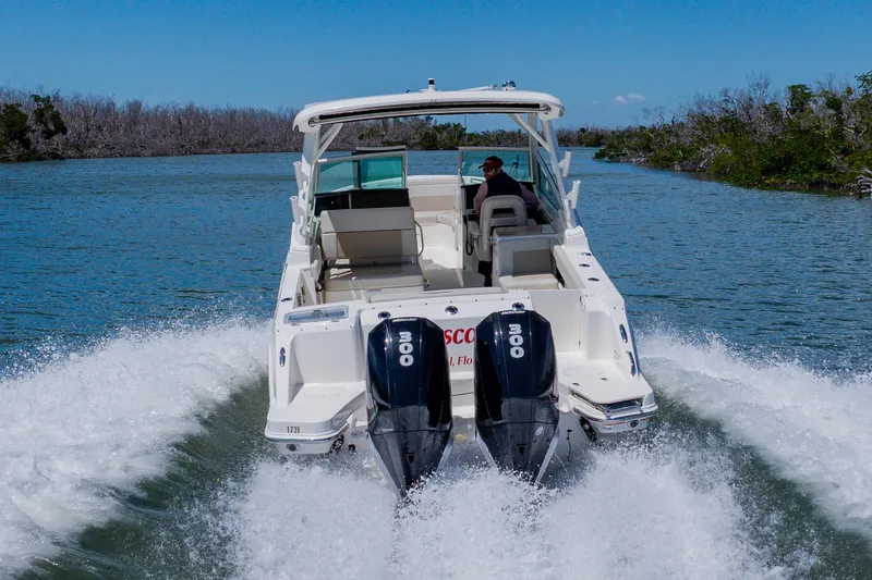 Slide: The Image of 2021 Boston Whaler 280 Vantage cruising on a scenic waterway with dual engines. - 14