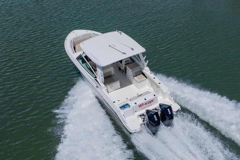 Slide: The Image of 2021 Boston Whaler 280 Vantage cruising on water with dual engines. - 15