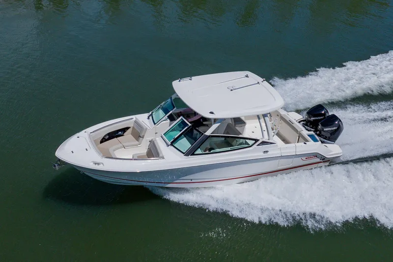Slide: The Image of 2021 Boston Whaler 280 Vantage cruising on water, showcasing sleek design and powerful engines. - 16