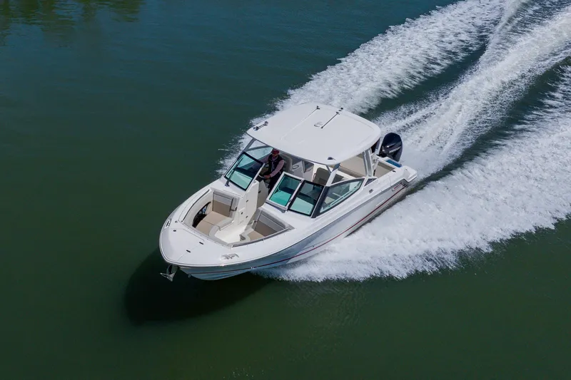 Slide: The Image of 2021 Boston Whaler 280 Vantage cruising on water, aerial view. - 17