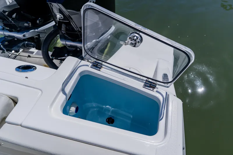 Slide: The Image of Open storage compartment on a 2021 Boston Whaler 280 Vantage boat, near water. - 23