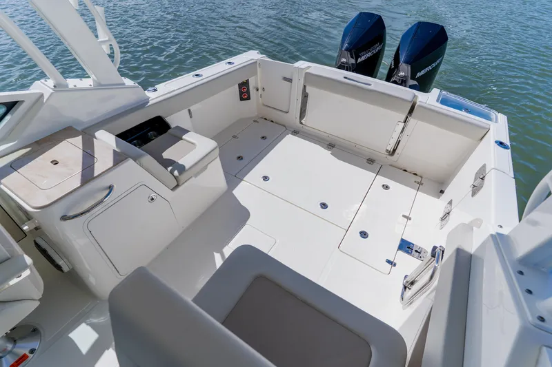 Slide: The Image of 2021 Boston Whaler 280 Vantage boat interior with dual Mercury engines on water. - 25