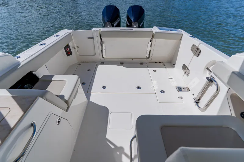 Slide: The Image of 2021 Boston Whaler 280 Vantage boat deck with seating and twin Mercury engines. - 26
