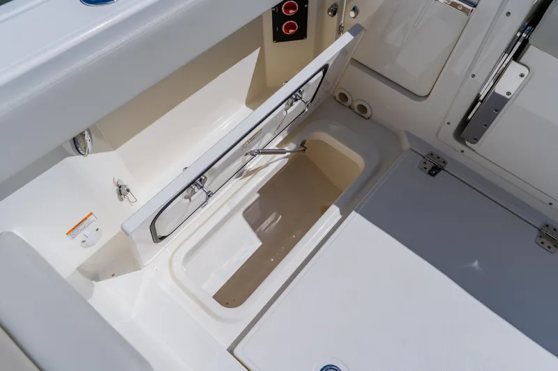 Slide: The Image of 2021 Boston Whaler 280 Vantage storage compartment with open hatch, showcasing interior details. - 33