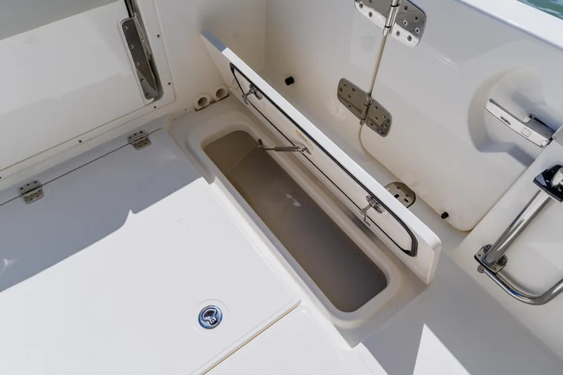 Slide: The Image of Open storage compartment on a 2021 Boston Whaler 280 Vantage boat deck. - 34