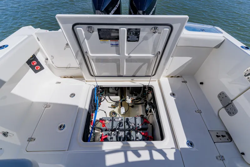 Slide: The Image of 2021 Boston Whaler 280 Vantage boat engine compartment with open hatch, showcasing internal components. - 35