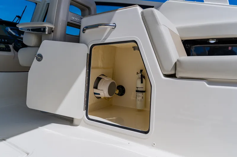 Slide: The Image of Storage compartment on a 2021 Boston Whaler 280 Vantage boat, featuring safety equipment. - 40