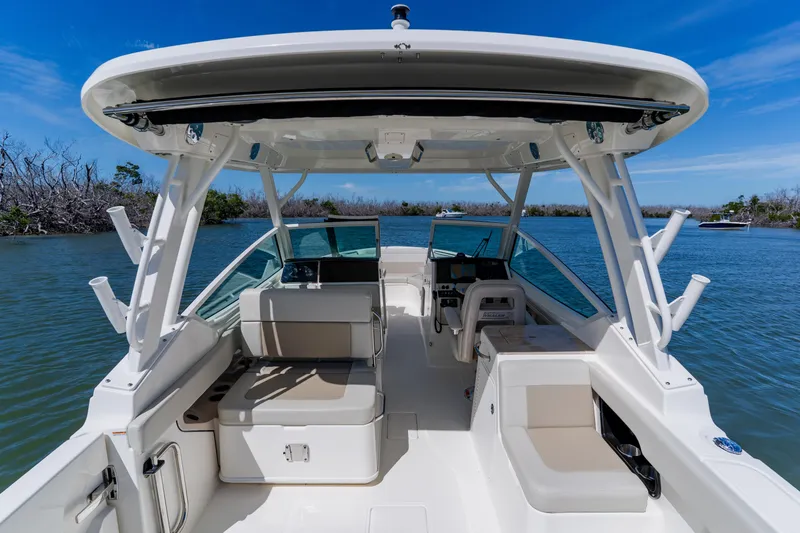 Slide: The Image of 2021 Boston Whaler 280 Vantage boat interior with seating, helm, and water view. - 43