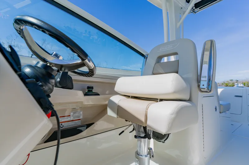 Slide: The Image of 2021 Boston Whaler 280 Vantage helm with steering wheel and comfortable seating. - 48
