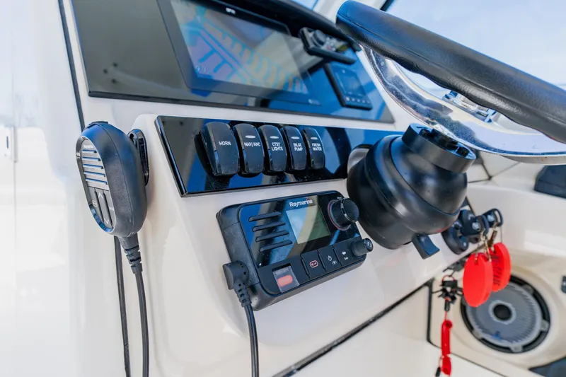 Slide: The Image of Control panel of a 2021 Boston Whaler 280 Vantage boat with steering wheel and electronics. - 50