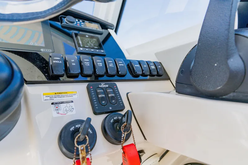 Slide: The Image of Control panel of a 2021 Boston Whaler 280 Vantage boat, featuring switches and controls. - 51