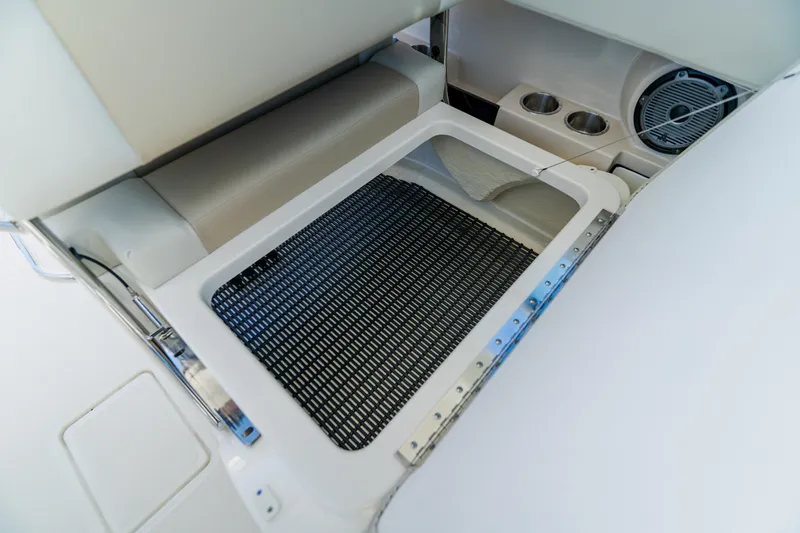 Slide: The Image of 2021 Boston Whaler 280 Vantage boat storage compartment with seating and speaker. - 56