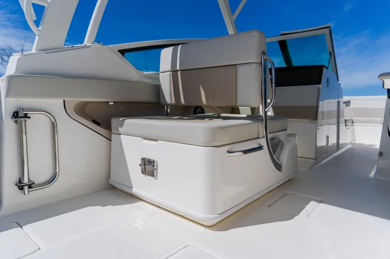 Slide: The Image of 2021 Boston Whaler 280 Vantage interior with seating and storage, under clear blue sky. - 62