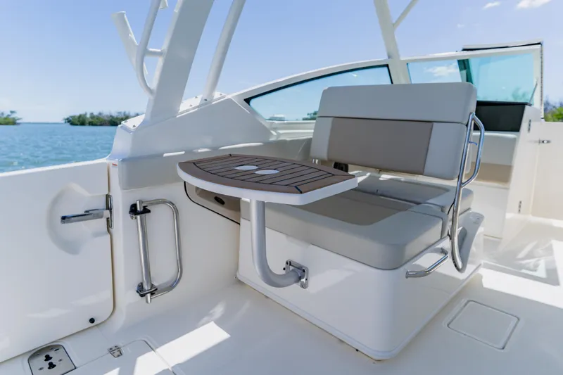 Slide: The Image of 2021 Boston Whaler 280 Vantage boat interior with seating and table, ocean view. - 63