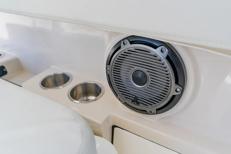 Slide: The Image of Speaker and cup holders on 2021 Boston Whaler 280 Vantage boat interior. - 65