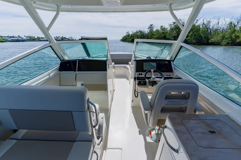 Slide: The Image of 2021 Boston Whaler 280 Vantage boat interior with helm, seating, and scenic water view. - 66