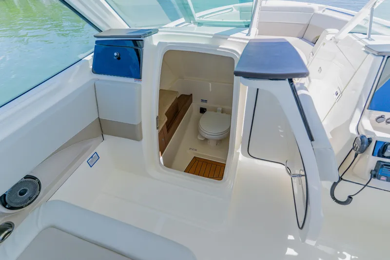 Slide: The Image of 2021 Boston Whaler 280 Vantage boat interior with open cabin door and visible toilet. - 67